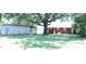 Spacious backyard with mature tree, building and partial view of the rear brick home at 1926 Eastway Dr, Charlotte, NC 28205