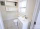 Clean bathroom with a white vanity, updated fixtures, shelving, and a large window at 1926 Eastway Dr, Charlotte, NC 28205