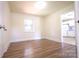 Bedroom featuring plank flooring, light walls and one window at 1926 Eastway Dr, Charlotte, NC 28205