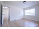 Bright bedroom featuring hardwood floors, neutral walls, closet, and natural light from a window at 1926 Eastway Dr, Charlotte, NC 28205