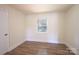 Bedroom with plank flooring, light walls and one window at 1926 Eastway Dr, Charlotte, NC 28205