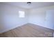 Bright, neutral bedroom with hardwood floors, a window and light fixture at 1926 Eastway Dr, Charlotte, NC 28205