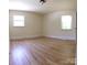 Bright, neutral bedroom with hardwood floors and two windows at 1926 Eastway Dr, Charlotte, NC 28205