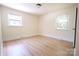 Bright, neutral bedroom with hardwood floors and two windows at 1926 Eastway Dr, Charlotte, NC 28205