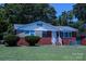 Quaint red brick home featuring a neatly kept lawn and classic architectural elements at 1926 Eastway Dr, Charlotte, NC 28205