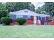 Inviting brick home with a lush green lawn and decorative shrubs at 1926 Eastway Dr, Charlotte, NC 28205