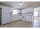 Bright kitchen with white cabinets, modern appliances, and a view of the adjacent room at 1926 Eastway Dr, Charlotte, NC 28205