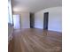 Sunny living room showcasing hardwood floors, neutral paint and two entryways at 1926 Eastway Dr, Charlotte, NC 28205