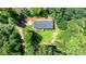 Aerial perspective of a well-maintained house featuring a new roof, surrounded by lush trees and a quaint yard at 200 Vista Pointe Dr, Stony Point, NC 28678