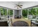 Spacious back porch with comfortable seating, a ceiling fan, and views of the surrounding greenery at 200 Vista Pointe Dr, Stony Point, NC 28678