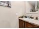 Bathroom featuring a white sink with dark wood vanity and a decorative mirror at 200 Vista Pointe Dr, Stony Point, NC 28678