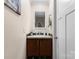Bathroom features a vanity with dark wood cabinets and a decorative mirror at 200 Vista Pointe Dr, Stony Point, NC 28678