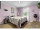 Cozy bedroom with a queen-size bed, soft lighting, and a large window with bright sunlight at 200 Vista Pointe Dr, Stony Point, NC 28678