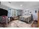 Spacious bedroom with a large window, seating area, and a comfortable bed at 200 Vista Pointe Dr, Stony Point, NC 28678