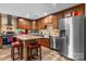 Well-equipped kitchen features stainless steel appliances, dark wood cabinets, and an island with breakfast bar at 200 Vista Pointe Dr, Stony Point, NC 28678