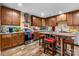 Modern kitchen boasts dark wood cabinets, stainless steel appliances, and a cozy island with seating at 200 Vista Pointe Dr, Stony Point, NC 28678