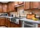 Updated kitchen with stainless steel sink, modern appliances, and sleek countertops with wood cabinets at 200 Vista Pointe Dr, Stony Point, NC 28678
