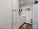 Clean laundry room featuring modern washer and dryer, storage cabinets, and hardwood style flooring at 200 Vista Pointe Dr, Stony Point, NC 28678