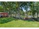 A spacious backyard featuring waterfront access, mature trees, and various seating options for relaxation at 21212 Rio Oro Dr, Cornelius, NC 28031