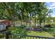 Lush backyard leading to the lake, featuring mature trees and perfect for relaxing and enjoying nature at 21212 Rio Oro Dr, Cornelius, NC 28031