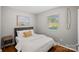 Cozy bedroom featuring hardwood floors, a comfy bed, and a large window for natural light at 21212 Rio Oro Dr, Cornelius, NC 28031