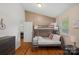 Cozy bunk room with wood floors, natural light, and neutral-colored walls at 21212 Rio Oro Dr, Cornelius, NC 28031