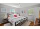 Bright bedroom with hardwood floors, white bedding, decorative art, and ample natural light at 21212 Rio Oro Dr, Cornelius, NC 28031