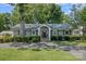 Charming home with welcoming front porch, well-maintained lawn, and mature trees at 21212 Rio Oro Dr, Cornelius, NC 28031