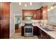 Well-equipped kitchen featuring stainless steel appliances, granite countertops, and dark wood cabinetry at 21212 Rio Oro Dr, Cornelius, NC 28031