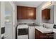 Functional laundry room with modern washer/dryer, sink, and ample storage cabinets at 21212 Rio Oro Dr, Cornelius, NC 28031