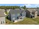 Aerial view of the backyard features a covered patio with chairs, green grass and dark-blue siding at 235 Boxelder Rd, Clover, SC 29710