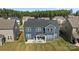 Aerial view of the backyard features a covered patio with chairs, green grass and dark-blue siding at 235 Boxelder Rd, Clover, SC 29710