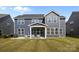 Spacious backyard with a covered patio featuring outdoor seating, lush green grass and dark-blue siding at 235 Boxelder Rd, Clover, SC 29710