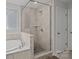 Tiled shower with glass door next to a soaking tub in a bright bathroom at 235 Boxelder Rd, Clover, SC 29710