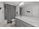Bathroom features a large mirror, single sink with gray cabinetry, shower and tub with a black and white checked shower curtain at 235 Boxelder Rd, Clover, SC 29710