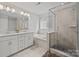 Elegant bathroom with a tub, glass shower, double vanity, and tiled walls at 235 Boxelder Rd, Clover, SC 29710