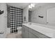 Neutral bathroom featuring a wide countertop, vanity, and tiled shower with a checkered curtain at 235 Boxelder Rd, Clover, SC 29710