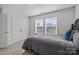 Bedroom showcases two large windows, gray carpet, black headboard bed with gray bedding and a closed white door at 235 Boxelder Rd, Clover, SC 29710