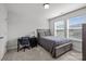 Bedroom features a bed with gray bedding, an office desk and chair and a single window with lots of natural light at 235 Boxelder Rd, Clover, SC 29710