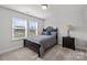 Bedroom with two large windows, gray carpet, black headboard bed with gray bedding and a single black bedside table at 235 Boxelder Rd, Clover, SC 29710