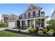 Beautiful two-story home boasts a landscaped yard, covered front porch, and attached two-car garage at 235 Boxelder Rd, Clover, SC 29710