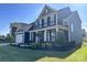 Charming two-story home showcasing professional landscaping and a manicured lawn in a residential neighborhood at 235 Boxelder Rd, Clover, SC 29710