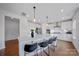 Modern kitchen featuring an island with seating, stainless steel appliances, and sleek white cabinetry at 235 Boxelder Rd, Clover, SC 29710