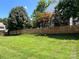 Large grassy backyard with a tall wood privacy fence, mature trees, and well maintained lawn at 2609 Lamp Post Ln, Kannapolis, NC 28081