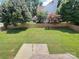 A spacious backyard with lush green grass and a wood fence seen through a window screen at 2609 Lamp Post Ln, Kannapolis, NC 28081