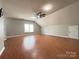 Large bonus room with wood flooring, ceiling fan, and natural light at 2609 Lamp Post Ln, Kannapolis, NC 28081