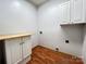 Convenient laundry room with storage cabinets and countertop at 2609 Lamp Post Ln, Kannapolis, NC 28081