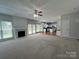 Spacious living room with fireplace, ceiling fan, and backyard access at 2609 Lamp Post Ln, Kannapolis, NC 28081