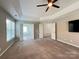 Spacious bedroom with ceiling fan and access to bathroom at 2609 Lamp Post Ln, Kannapolis, NC 28081