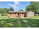 Backyard features a brick house, deck, and well-maintained lawn at 2705 Lowell Bethesda Rd, Gastonia, NC 28056